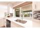 Bright kitchen view of sink area and backyard screened pool area at 936 Lassino Ct, Punta Gorda, FL 33950