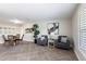 Open living room with tile floors, two gray chairs, and a dining area with seating for four at 936 Lassino Ct, Punta Gorda, FL 33950