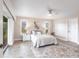 This main bedroom features light walls, beautiful decor, and a ceiling fan at 936 Lassino Ct, Punta Gorda, FL 33950