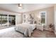 The main bedroom features light walls, a ceiling fan, and sliding glass doors to the patio at 936 Lassino Ct, Punta Gorda, FL 33950