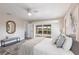 The main bedroom features light walls, decor, bench and sliding glass doors to the pool at 936 Lassino Ct, Punta Gorda, FL 33950