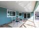 Covered patio with seating area and sliding glass doors to the interior at 936 Lassino Ct, Punta Gorda, FL 33950