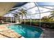 Beautiful screened pool with clear blue water and an extended patio area, perfect for swimming and sunbathing at 936 Lassino Ct, Punta Gorda, FL 33950