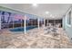 Screened-in pool area with tiled flooring, ample seating, and view of the surrounding neighborhood at 936 Lassino Ct, Punta Gorda, FL 33950