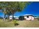 Beautiful backyard showcasing mature landscaping, green grass, and mature palm trees at 1675 Blue Lake Cir, Punta Gorda, FL 33983
