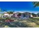 Expansive backyard with a screen-enclosed lanai and mature landscaping at 1675 Blue Lake Cir, Punta Gorda, FL 33983
