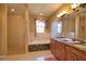 Elegant bathroom with a tiled walk-in shower, soaking tub, and dual vanity at 1675 Blue Lake Cir, Punta Gorda, FL 33983