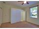 Bedroom featuring neutral carpet, a window with a view, and a closet with shelving at 1675 Blue Lake Cir, Punta Gorda, FL 33983