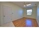 Clean bedroom with wood floors, large window letting in light, and ceiling fan with lighting fixture at 1675 Blue Lake Cir, Punta Gorda, FL 33983