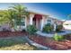 Charming single Gathering home with a well-manicured lawn, mature landscaping, and covered entryway at 1675 Blue Lake Cir, Punta Gorda, FL 33983