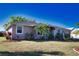Cozy single-story home with a well-maintained lawn, mature trees, and a covered entrance at 1675 Blue Lake Cir, Punta Gorda, FL 33983