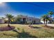 Cozy single-story home with a well-maintained lawn, mature trees, and a covered entrance at 1675 Blue Lake Cir, Punta Gorda, FL 33983