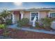 Charming single Gathering home with mature palms, flower beds, manicured lawn, covered entryway, and a statue at 1675 Blue Lake Cir, Punta Gorda, FL 33983