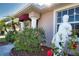 Charming single Gathering home with mature palms, flower beds, manicured lawn, covered entryway, and a statue at 1675 Blue Lake Cir, Punta Gorda, FL 33983