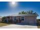 Charming single Gathering home with mature palms, immaculate lawn, and attached two-car garage at 1675 Blue Lake Cir, Punta Gorda, FL 33983