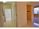 Hallway with tile floors, open doors, and neutral color scheme at 1675 Blue Lake Cir, Punta Gorda, FL 33983