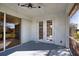 Enclosed lanai featuring ceiling fans, glass doors, and access to the lush outdoor area at 1675 Blue Lake Cir, Punta Gorda, FL 33983