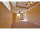 Bright main bedroom with ceiling fan and glass patio doors at 1675 Blue Lake Cir, Punta Gorda, FL 33983