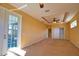 Spacious main bedroom with large windows, ceiling fan, and outdoor access at 1675 Blue Lake Cir, Punta Gorda, FL 33983