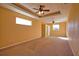 Spacious main bedroom featuring tray ceilings, ceiling fan, and large windows at 1675 Blue Lake Cir, Punta Gorda, FL 33983