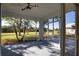 Relaxing screened porch overlooking a well-maintained backyard with tropical landscaping and a view of neighboring houses at 1675 Blue Lake Cir, Punta Gorda, FL 33983