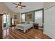 Spacious main bedroom with hardwood floors, ceiling fan, and ensuite access at 18042 Avonsdale Cir, Port Charlotte, FL 33948