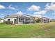 A spacious backyard featuring two screened-in lanais and well-maintained green grass, perfect for outdoor relaxation at 2153 Boxwood St, North Port, FL 34289