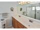 Bathroom featuring double vanity, large mirror, ample lighting, and a glass-enclosed shower at 2153 Boxwood St, North Port, FL 34289