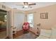 Bright bedroom featuring ceiling fan, a comfortable chair, and natural light at 2153 Boxwood St, North Port, FL 34289