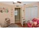 Charming bedroom with stylish decor, ceiling fan, and a view to another room at 2153 Boxwood St, North Port, FL 34289
