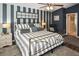 Well-decorated bedroom with striped accent wall, ceiling fan, and ample natural light at 2153 Boxwood St, North Port, FL 34289
