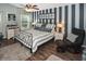 Bright bedroom featuring stylish striped walls, modern furnishings, and comfortable decor at 2153 Boxwood St, North Port, FL 34289