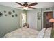 Airy bedroom with ceiling fan, closet, and natural light from the window at 2153 Boxwood St, North Port, FL 34289