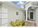 Covered entryway with stucco walls, decorative accents, and a charming front door at 2153 Boxwood St, North Port, FL 34289