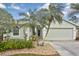 Close-up of the front entrance features decorative landscaping, and a two-car garage at 2153 Boxwood St, North Port, FL 34289