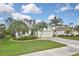 Charming single-story home with a well-manicured lawn, tropical landscaping, and a two-car garage at 2153 Boxwood St, North Port, FL 34289