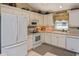 Well-lit kitchen with white cabinetry, modern appliances, and ample counter space at 2153 Boxwood St, North Port, FL 34289