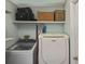 Functional laundry room with modern washer and dryer, and plenty of shelving at 2153 Boxwood St, North Port, FL 34289