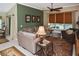 Cozy living room with neutral tones, comfortable seating, ceiling fan, and natural light at 2153 Boxwood St, North Port, FL 34289