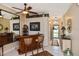 Stylish living area with a mirrored bar, tiled floors, and an arched doorway to the front entrance at 2153 Boxwood St, North Port, FL 34289