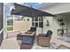 Inviting outdoor patio with comfortable seating and shade umbrella at 2153 Boxwood St, North Port, FL 34289