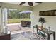 Cozy screened patio with seating, table, and view of the spacious backyard at 2153 Boxwood St, North Port, FL 34289