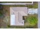Birds-eye view of the house, its roof, driveway, landscaping, and fencing at 2281 Tolbert St, Port Charlotte, FL 33948