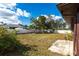Spacious backyard offering privacy, green space, and a view of the blue sky at 2281 Tolbert St, Port Charlotte, FL 33948