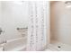 Well-lit bathroom features separate tub and shower with decorative shower curtain at 2281 Tolbert St, Port Charlotte, FL 33948