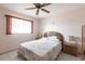 Cozy bedroom featuring neutral walls, tile flooring, and a ceiling fan to maximize comfort at 2281 Tolbert St, Port Charlotte, FL 33948