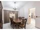 Dining area with chandelier, tile floors, wooden dining set, and view into the adjacent kitchen at 2281 Tolbert St, Port Charlotte, FL 33948