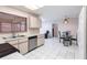 Functional kitchen with tile flooring, classic cabinetry, and stainless steel dishwasher at 2281 Tolbert St, Port Charlotte, FL 33948