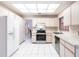 Bright kitchen features white tile floors and stainless steel appliances at 2281 Tolbert St, Port Charlotte, FL 33948