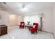 Comfortable living room with tile flooring, ceiling fan, and bright natural light through the curtains at 2281 Tolbert St, Port Charlotte, FL 33948